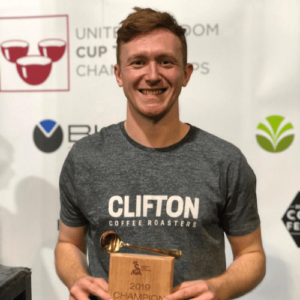 Clifton Coffee MD Josh Clarke holding an award