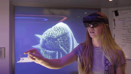 Woman wearing Microsoft Mesh VR headset