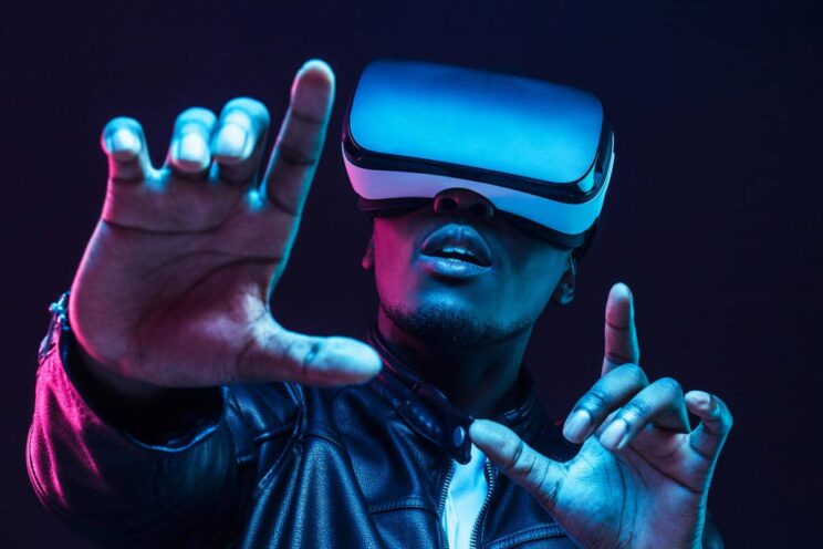 Man wearing white VR headset reaching out with his hands