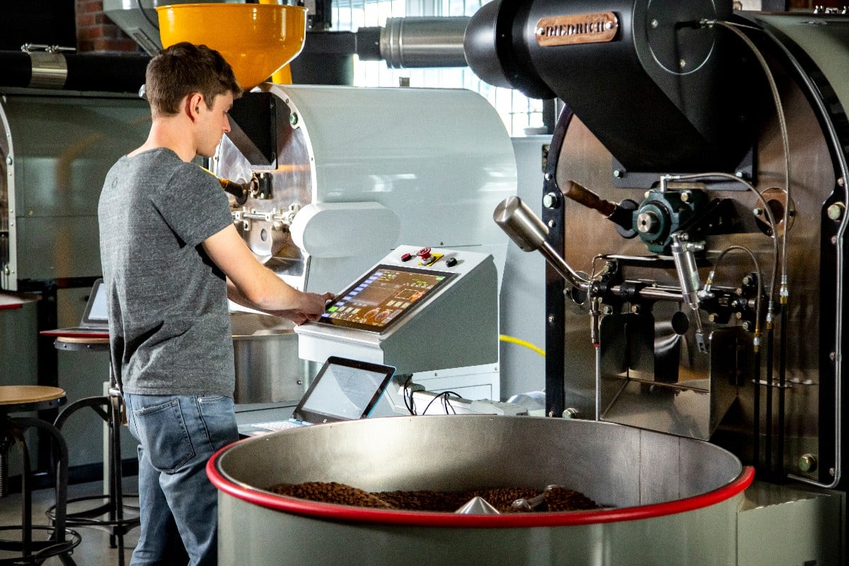 Man operating machinery with user interface on machine