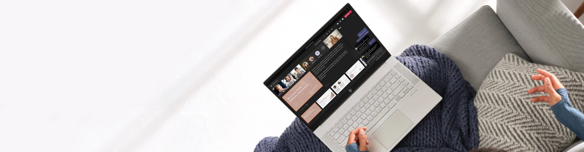 woman in a teams meeting on laptop sat on sofa with blanket