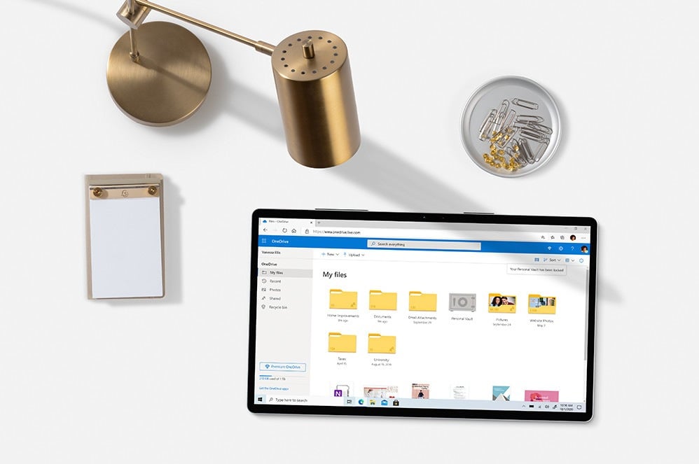 Tablet with one drive on desk tablet with one drive on a desk with notepad and a lamp and paperclips