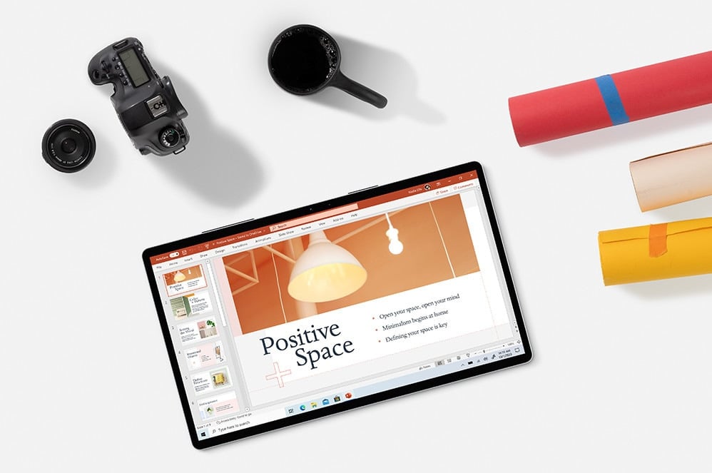 tablet with powerpoint open on a desk with a camera and a