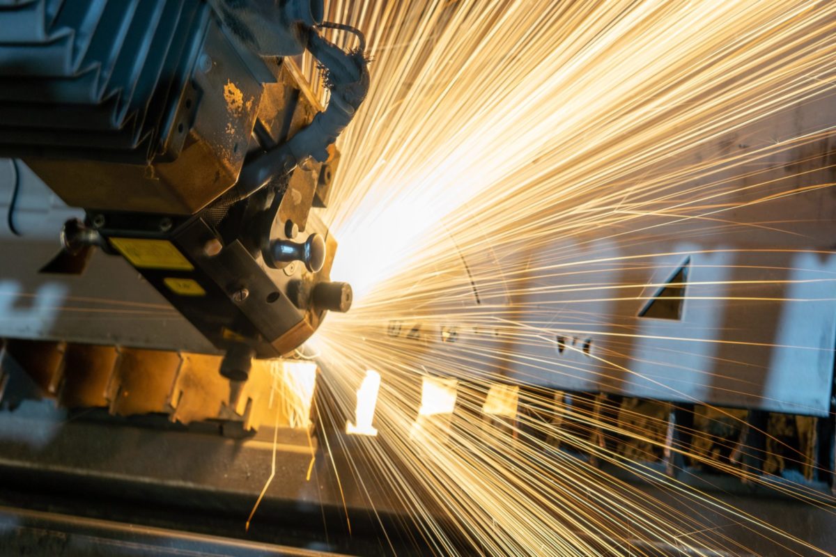 Heavy machinery in use with sparks flying