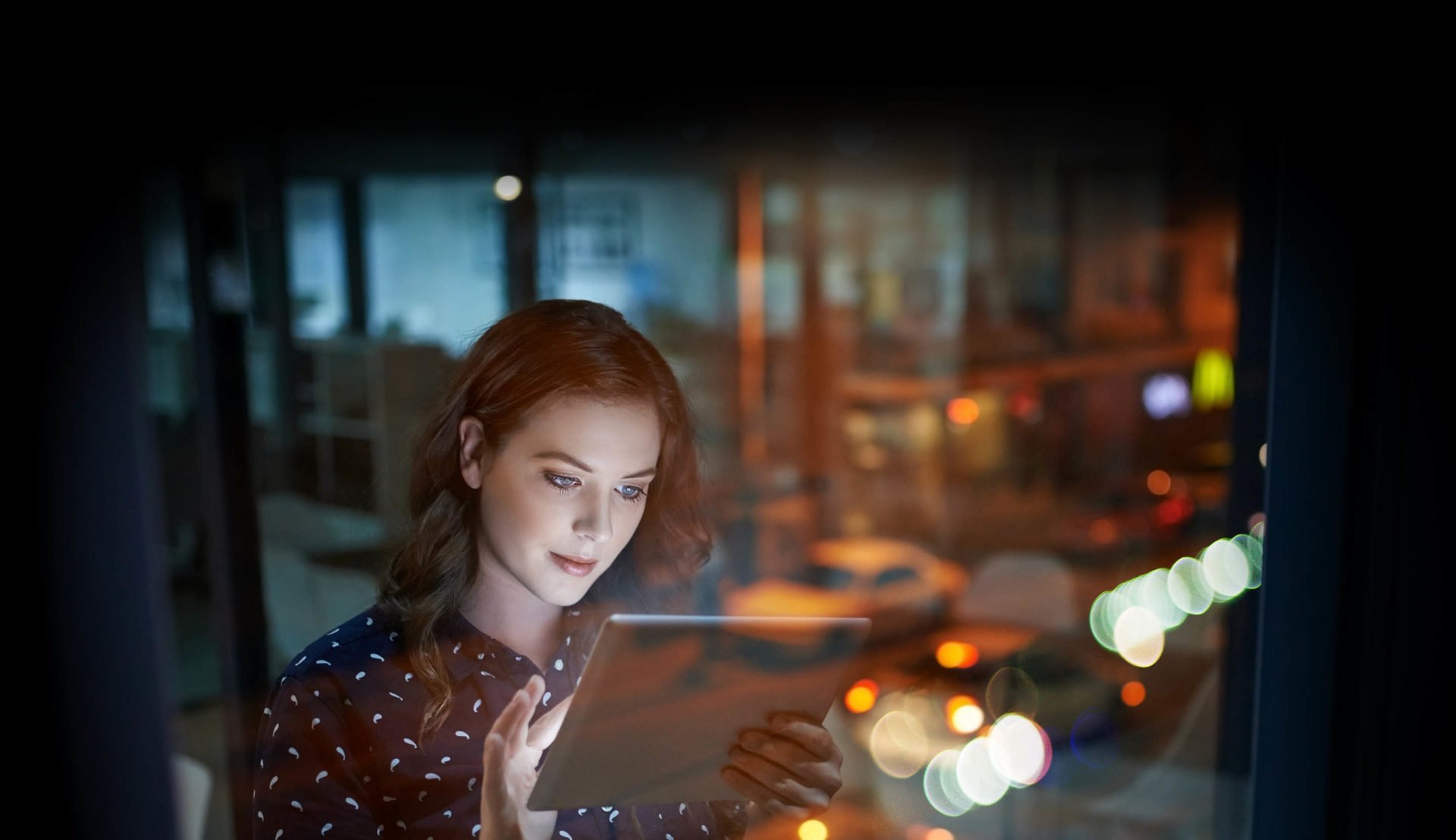 Professional young woman in a city office using her tablet device to become an automated business