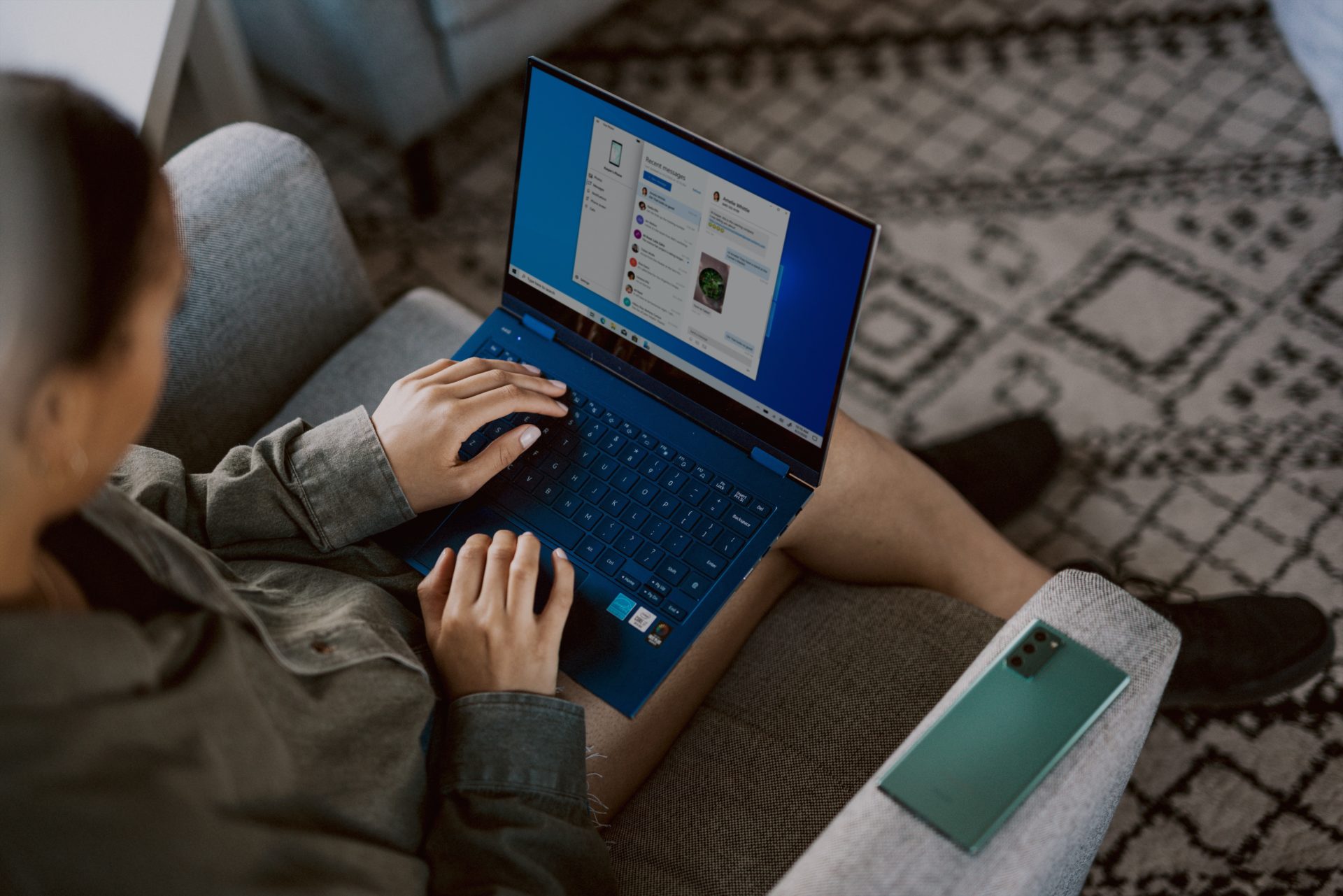 Woman working from home with laptop on her lap