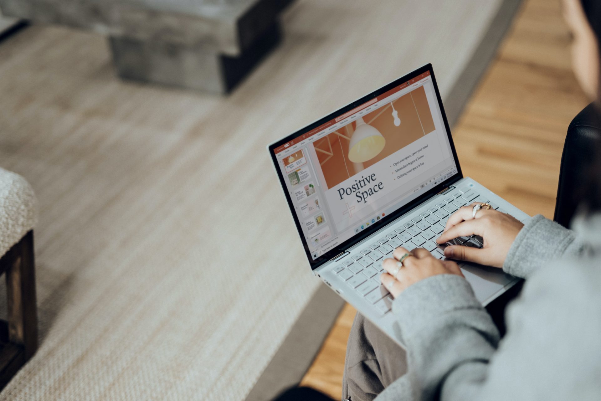 Woman creating a PowerPoint presentation using a Surface Laptop