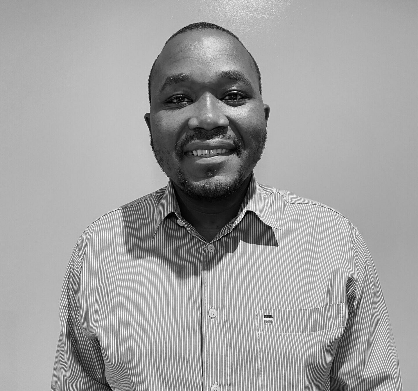 Ndumeliso Radzilani standing in front of white wall