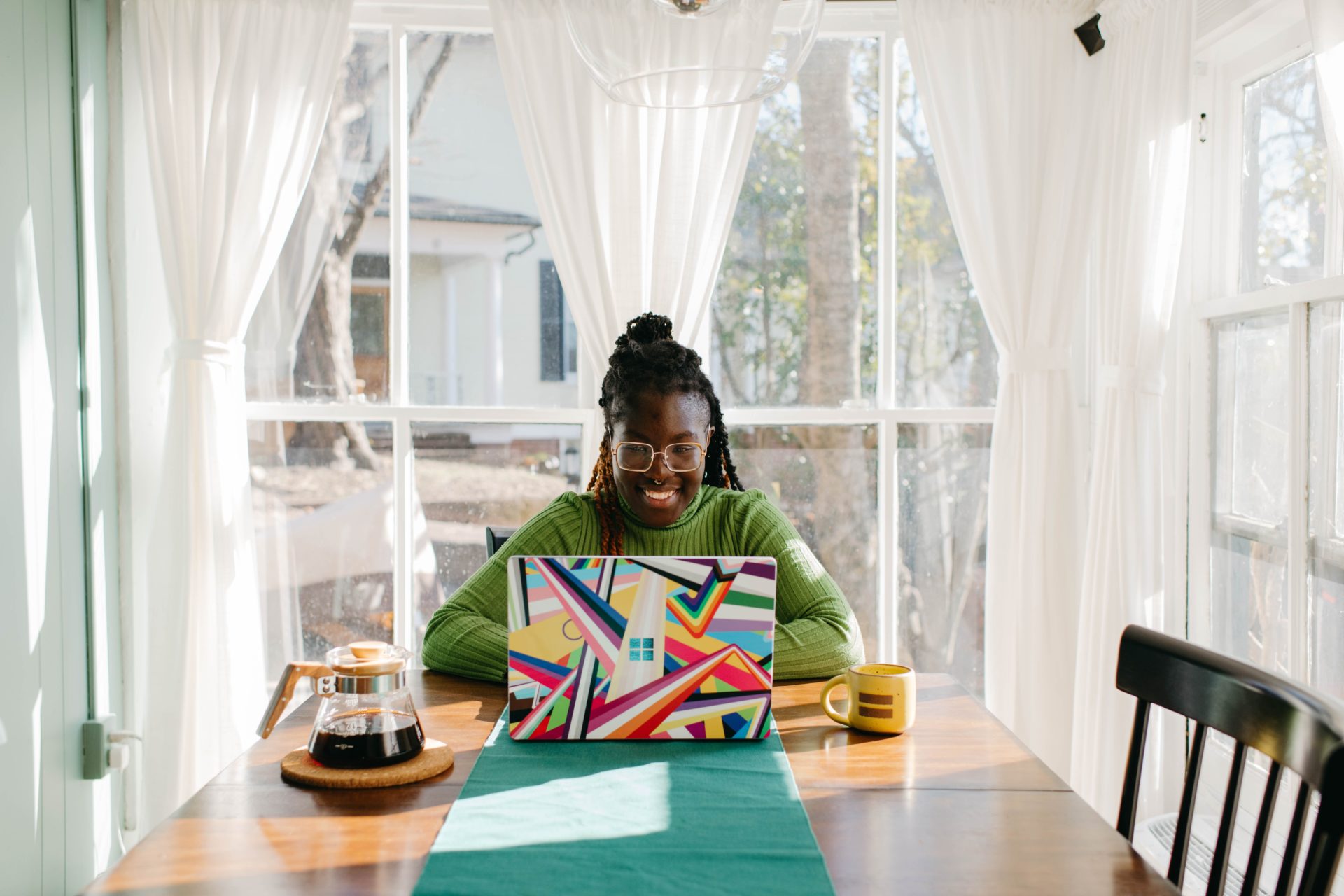Woman Working From Home Smiling woman working from home on colourful Microsoft Surface Laptop