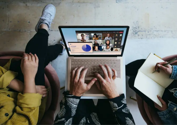 Laptop-in-the-hands-of-a-man-near-the-other-people-744×526.jpg