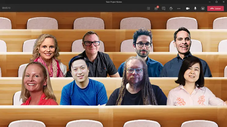 a group of people on a teams call, with a lecture hall style background