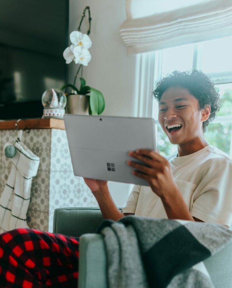 Man smiling with Microsoft Surface Tablet