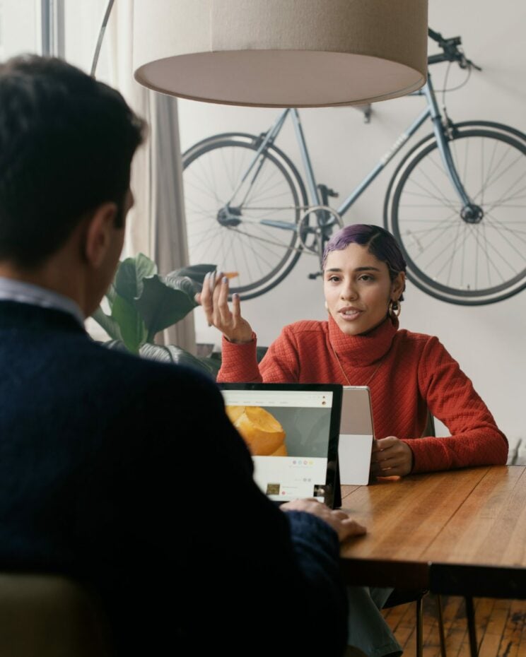 Meeting between coworkers whilst using Microsoft Surface Tablet