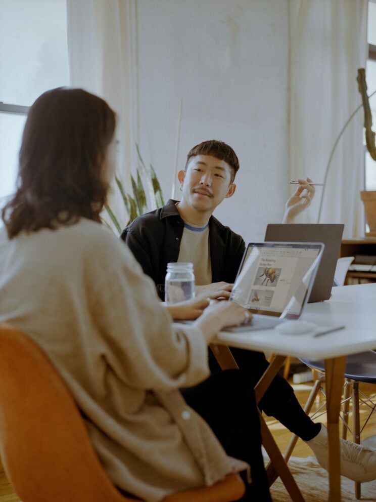 Small meeting with team members using Microsoft Surface Laptops