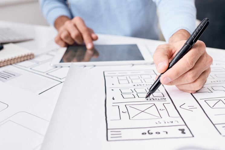 Working on app planner design for gadgets Close-up of unrecognizable UI engineer using digital tablet while working on app planner design for gadgets