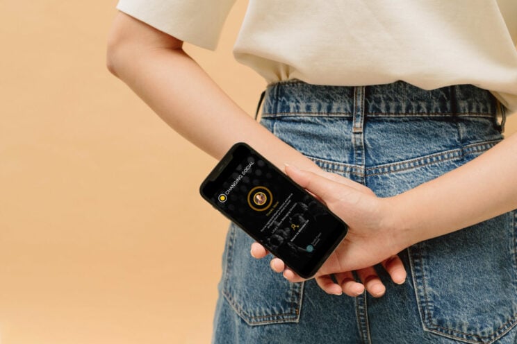 Woman holding phone Woman holding phone behind her back
