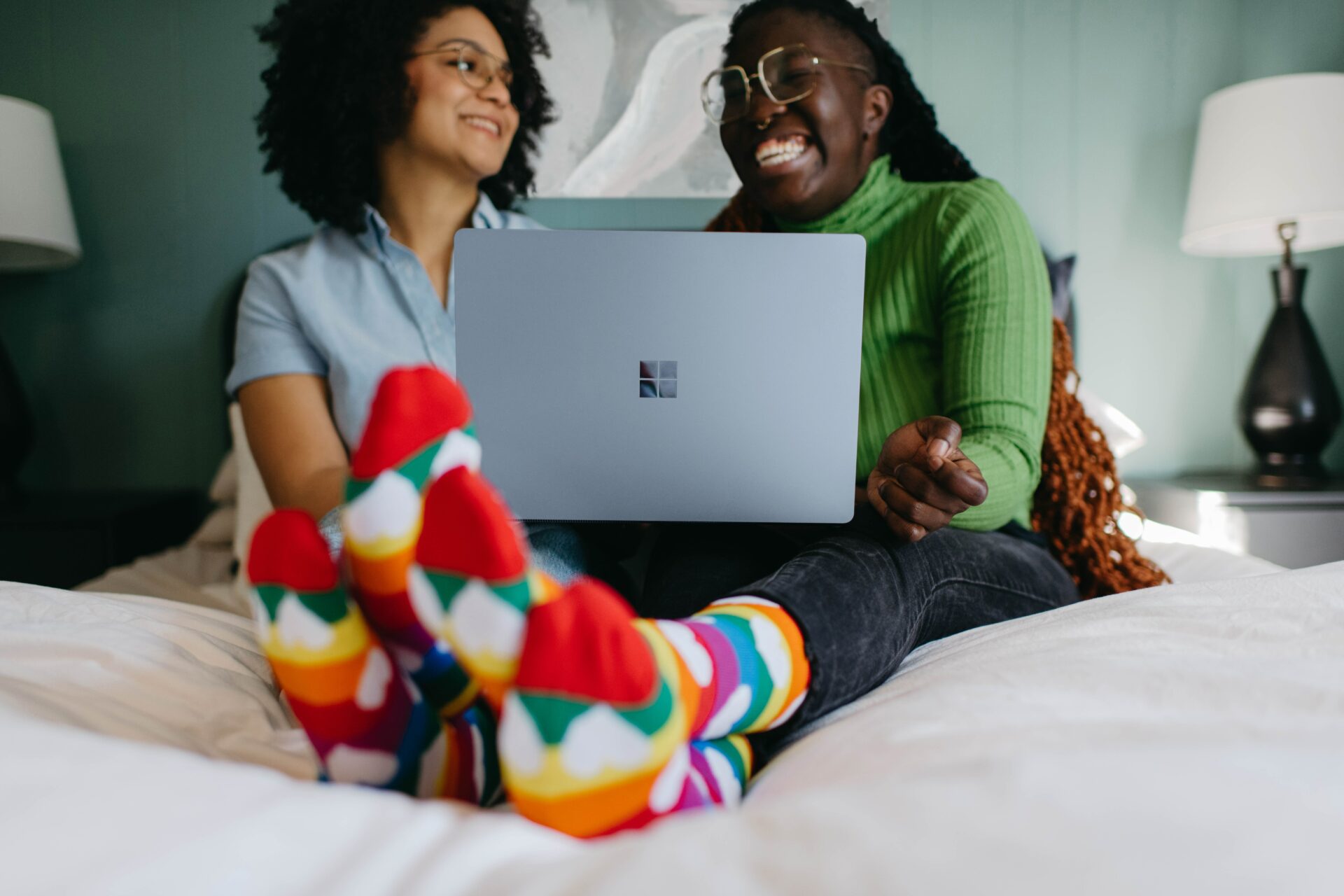 Two Friends Laughing while using a Microsoft Surface Laptop