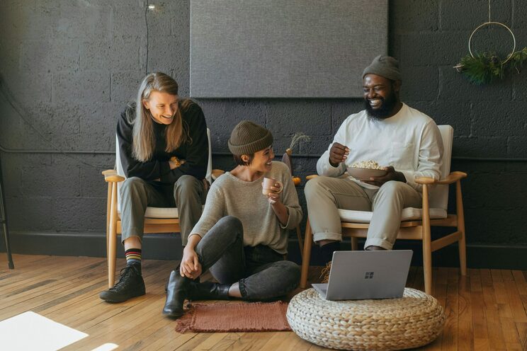 A group of people smiling with a Microsoft Surface.